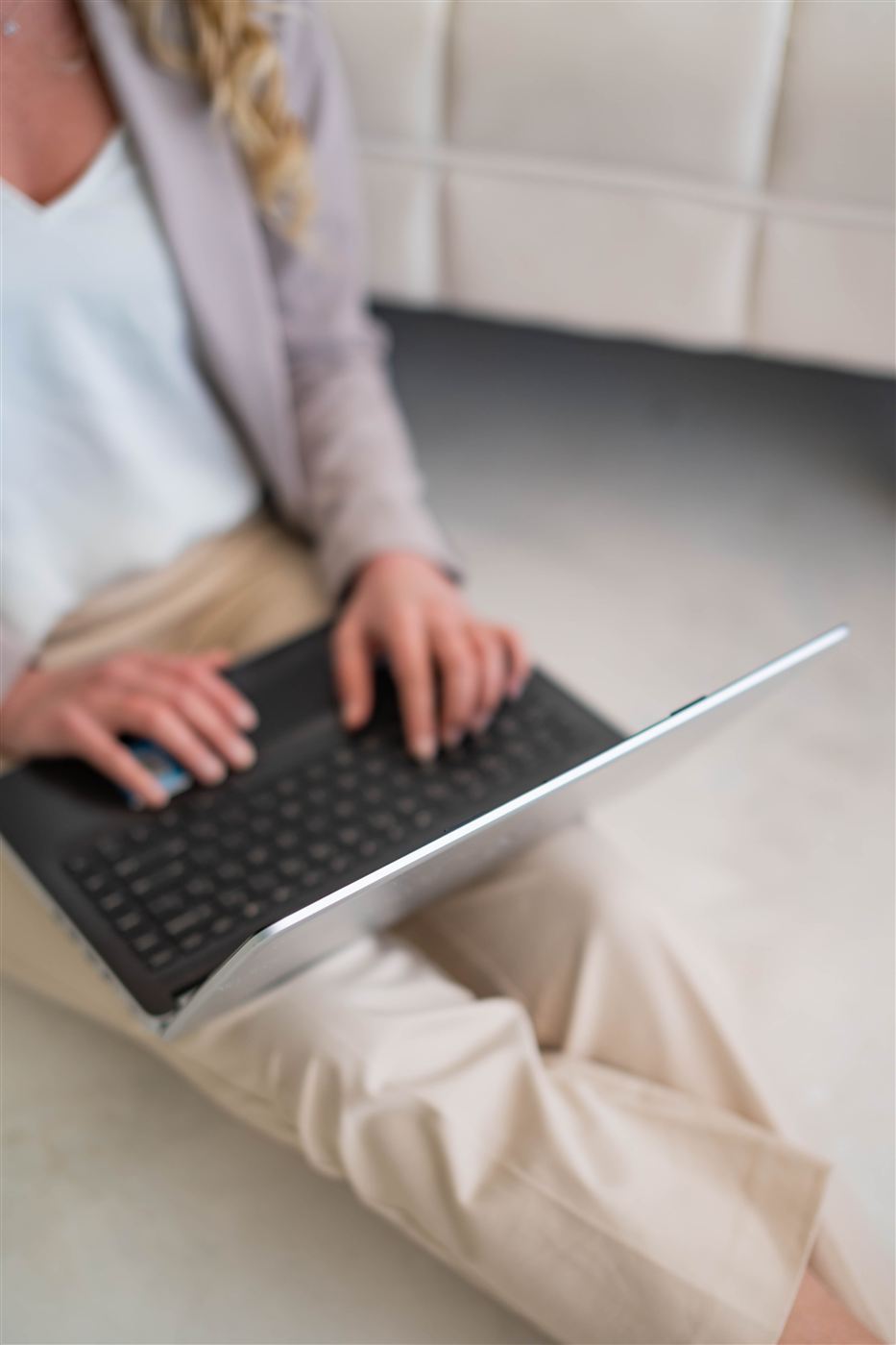 A close view of hands typing on a laptop keyboard